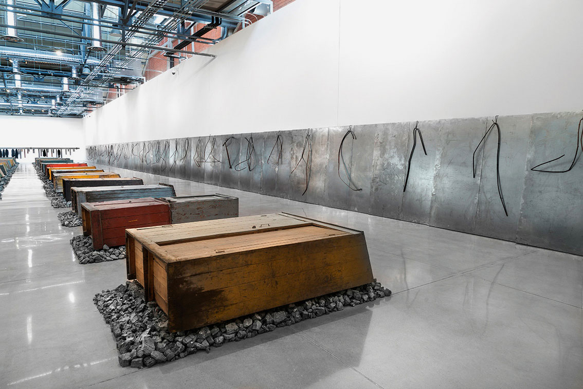 Jannis Kounellis, from left, Untitled, 2016, 24 Ferrocarril Mexicano closets, iron fragments, each 260 x 210 cm; Untitled, 2016, iron, iron bars, each 200 x 180 cm, installation view at Museo-Espacio Ciudad De Las Artes, Aguascalientes, Mexico, 2016. Artworks © Jannis Kounellis 