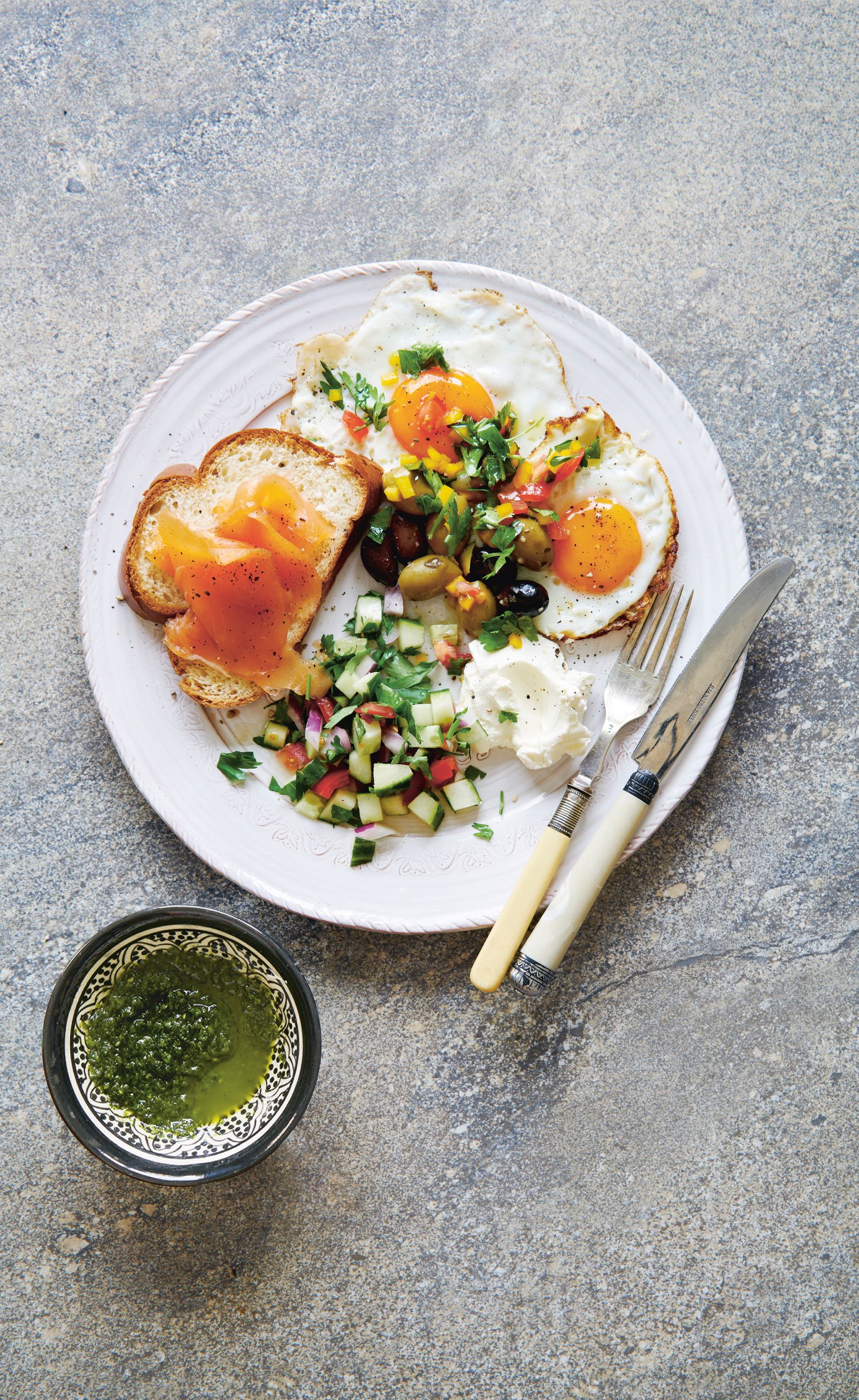 Israel breakfast plate (top) with a dish of schug (bottom)